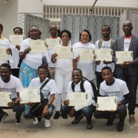 Group of people each holding a certificate